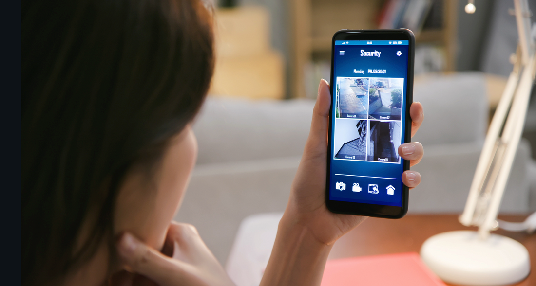 A person looking at a security camera feed on a smartphone.